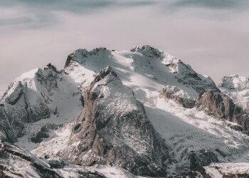 Snowy mountain peaks with cloudy sky