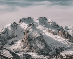Snowy mountain peaks with cloudy sky