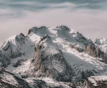 Snowy mountain peaks with cloudy sky