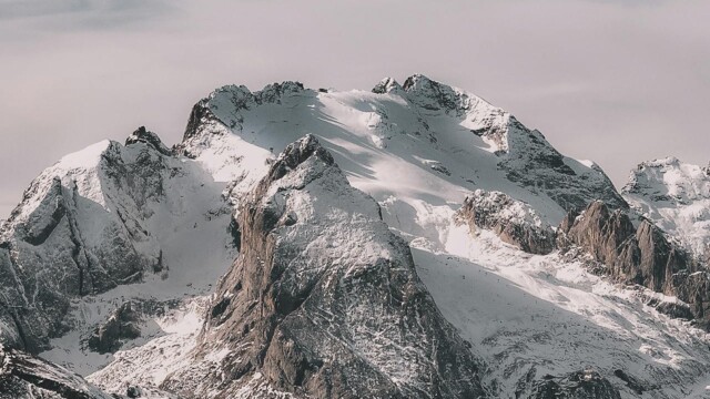 Snowy mountain peaks with cloudy sky