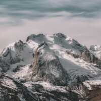 Snowy mountain peaks with cloudy sky