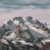Snowy mountain peaks with cloudy sky