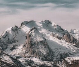 Snowy mountain peaks with cloudy sky