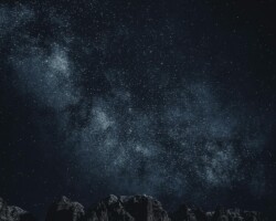 Starry sky with Milky Way over mountains