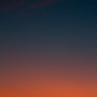 Crescent moon and fiery orange sunset horizon