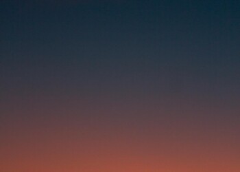 Crescent moon and fiery orange sunset horizon