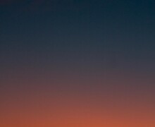 Crescent moon and fiery orange sunset horizon